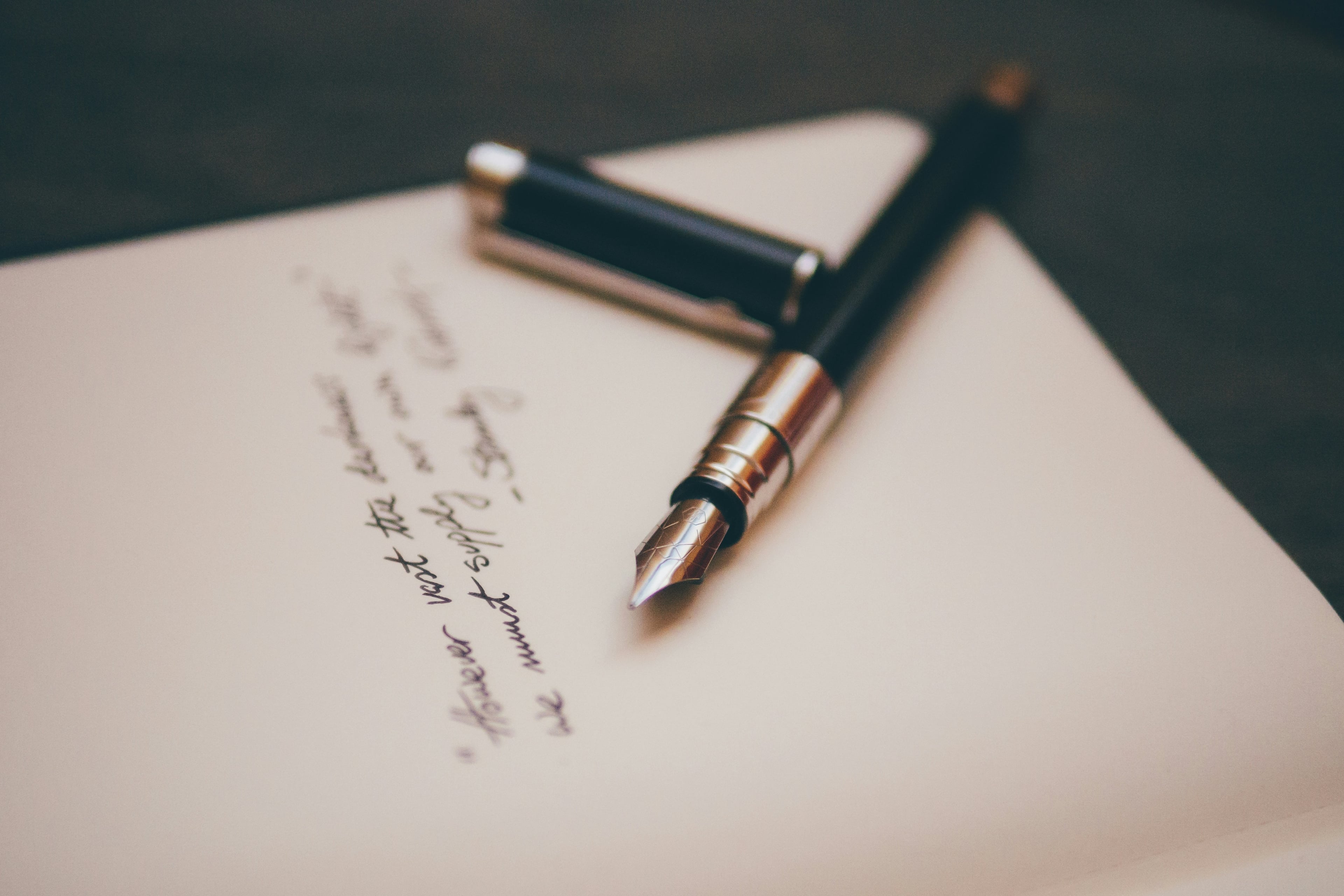 Fountain pen resting on a handwritten letter